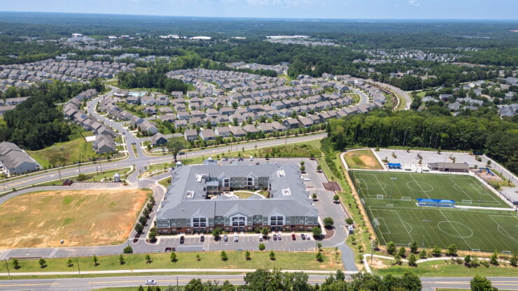 A vibrant community surrounded by lush greenery, offering comfort and connection for all residents.