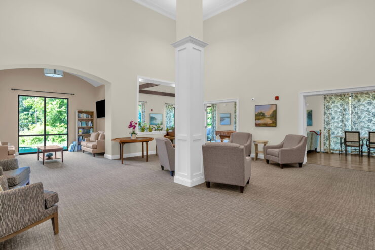 A welcoming communal space with ample natural light, inviting seating, and vibrant decor fosters connection and comfort.