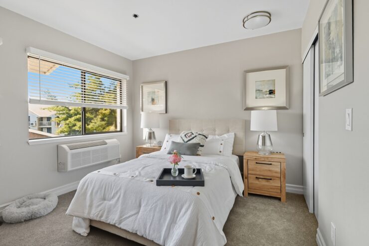 A bright, inviting bedroom with soft decor, showcasing comfort and a welcoming atmosphere.