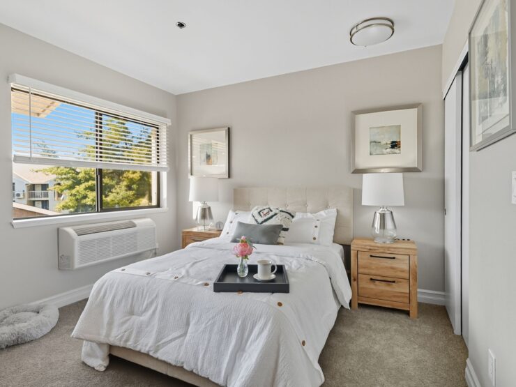 A bright, inviting bedroom with soft decor, showcasing comfort and a welcoming atmosphere.
