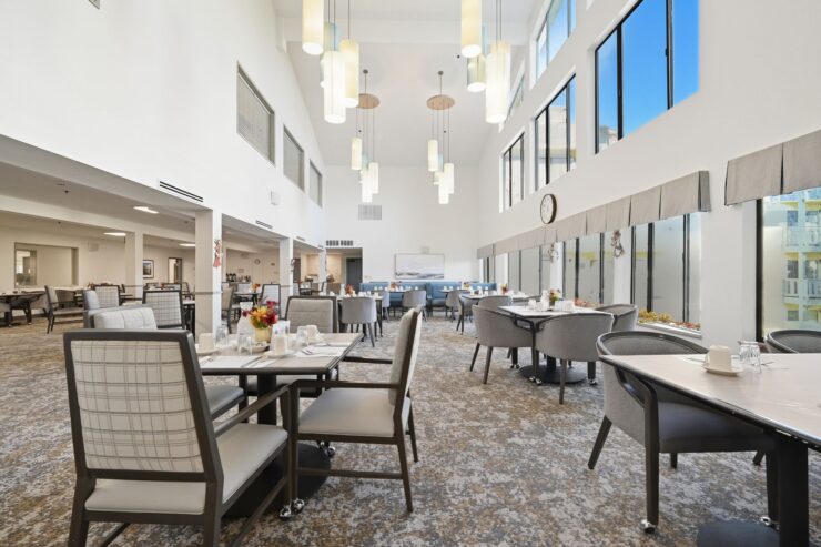 Bright and inviting dining area, featuring spacious tables, cheerful decor, and large windows for natural light.