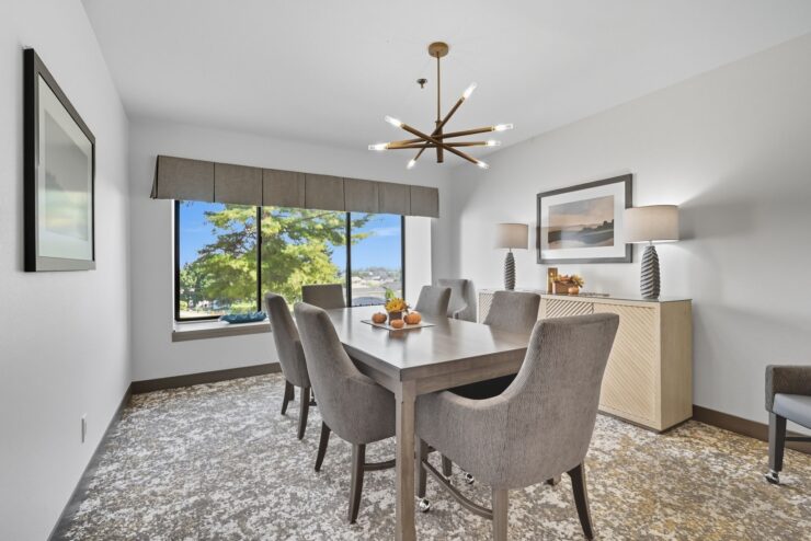 A bright dining area with a welcoming atmosphere, featuring elegant furnishings and a lovely view.