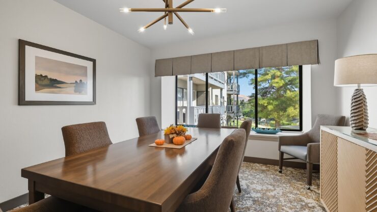 Bright and inviting dining area, perfect for gatherings, with elegant decor and views of nature.