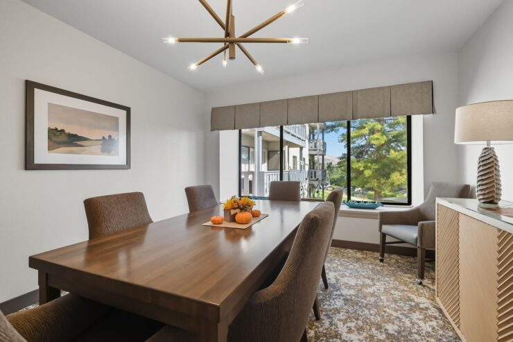 Bright and inviting dining area, perfect for gatherings, with elegant decor and views of nature.
