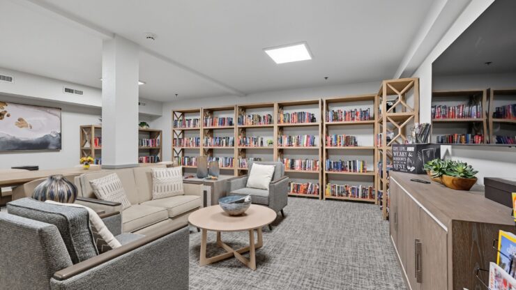 A welcoming reading area filled with books, inviting seating, and a warm atmosphere for community gatherings.