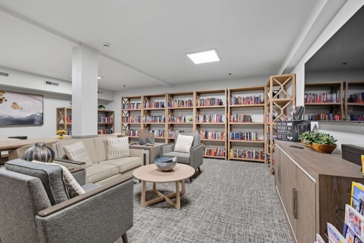 A welcoming reading area filled with books, inviting seating, and a warm atmosphere for community gatherings.