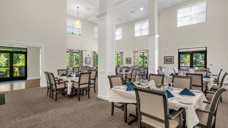 Bright, inviting dining area with elegant tables, fostering community and comfort for residents.