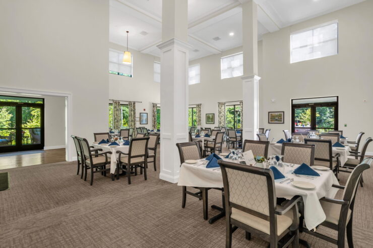 Bright, inviting dining area with elegant tables, fostering community and comfort for residents.