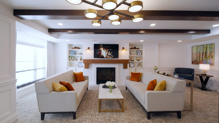 Inviting lounge with soft seating, warm lighting, and a welcoming fireplace, perfect for community gatherings.