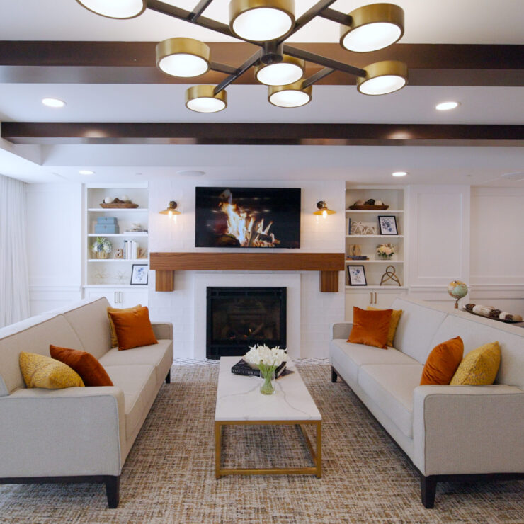 Inviting lounge with soft seating, warm lighting, and a welcoming fireplace, perfect for community gatherings.