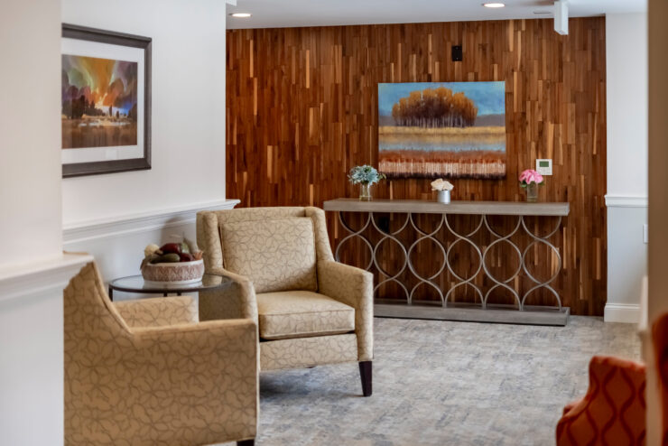 A welcoming lounge features elegant seating and warm wood accents, fostering a sense of community and comfort.