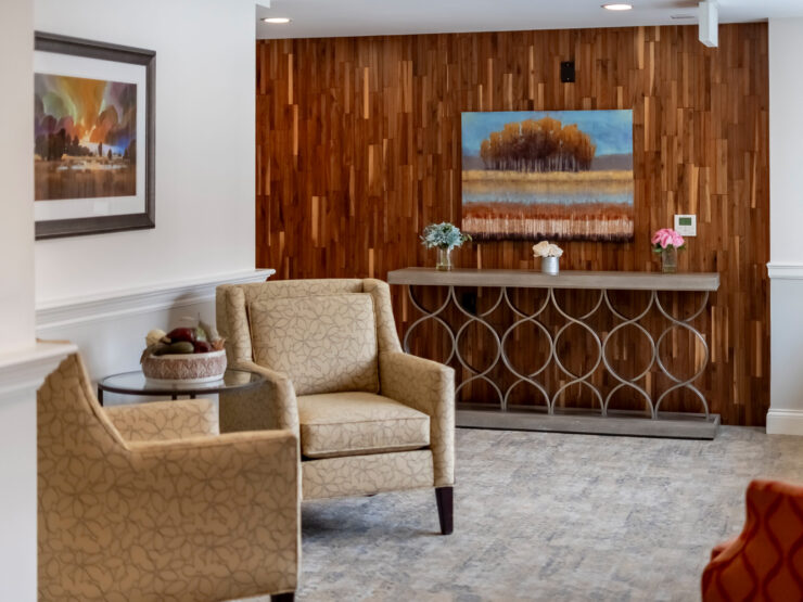 A welcoming lounge features elegant seating and warm wood accents, fostering a sense of community and comfort.