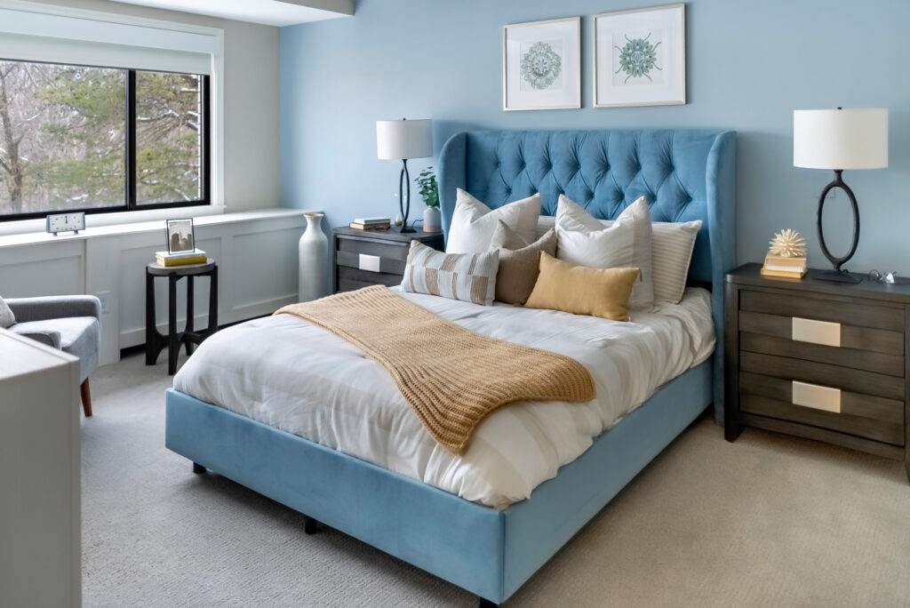 A serene bedroom featuring a plush bed, soft colors, and inviting decor, promoting comfort and community.