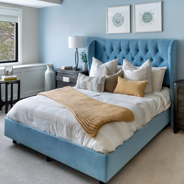 A serene bedroom featuring a plush bed, soft colors, and inviting decor, promoting comfort and community.