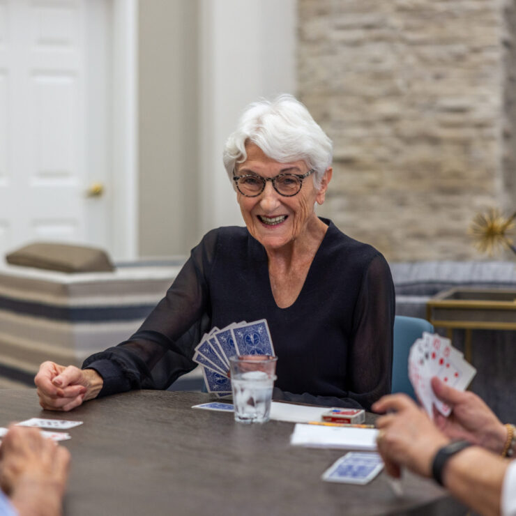 Lively card game among friends fosters joy and connection in a welcoming community space.