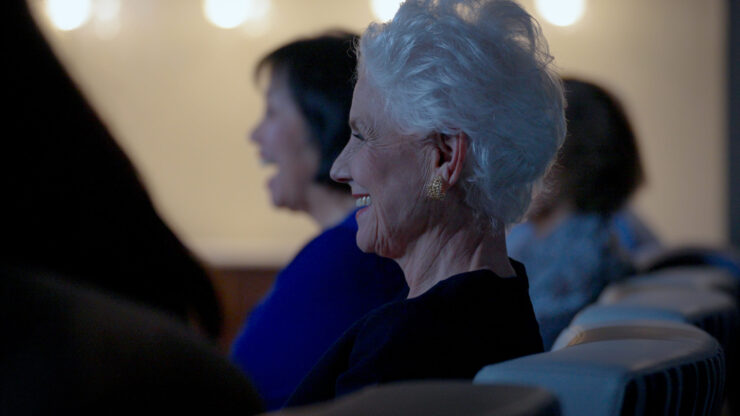 A joyful gathering, where smiling residents share laughter and warmth in a welcoming environment.