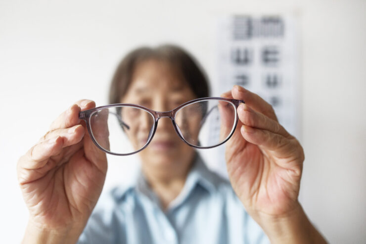 A warm moment showcasing a resident joyfully holding glasses, embodying community and care.