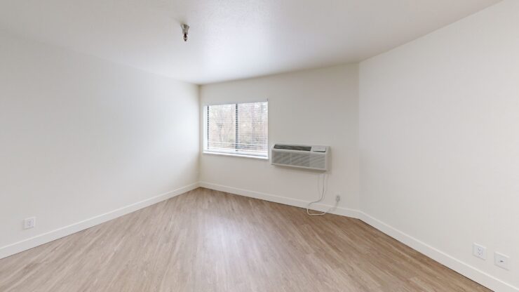 Bright and airy room with large windows, inviting warmth and a sense of community comfort.