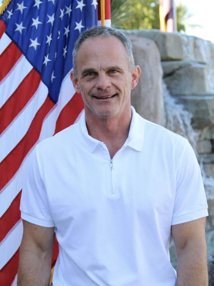 A welcoming atmosphere with a friendly individual beside a vibrant American flag, symbolizing community spirit.