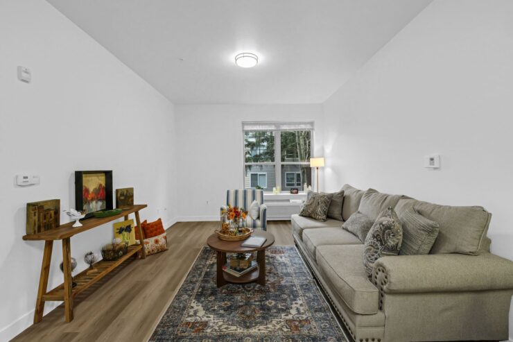 A bright, inviting living space with comfortable seating and warm decor, perfect for community gatherings.