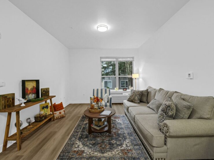 A bright, inviting living space with comfortable seating and warm decor, perfect for community gatherings.