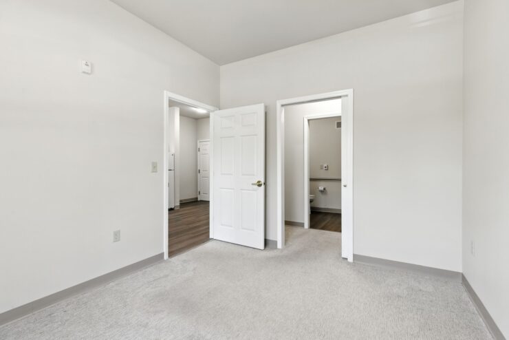 Bright, clean interior space with access to kitchen and bathroom, designed for comfort and ease.
