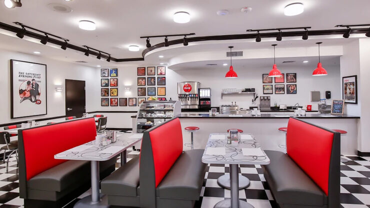 A vibrant dining area invites connection, featuring cozy booths and cheerful decor, perfect for community gatherings.