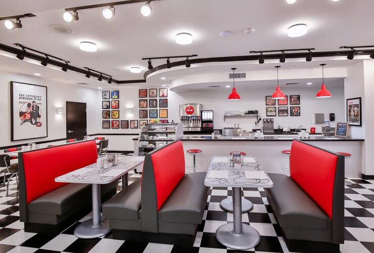 A vibrant dining area invites connection, featuring cozy booths and cheerful decor, perfect for community gatherings.