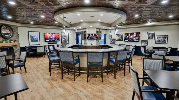 The inviting lounge features comfortable seating, warm lighting, and engaging decor, fostering community and connection.