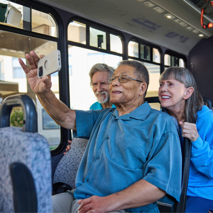A joyful moment shared among friends on a bus, capturing laughter and connection in a welcoming atmosphere.
