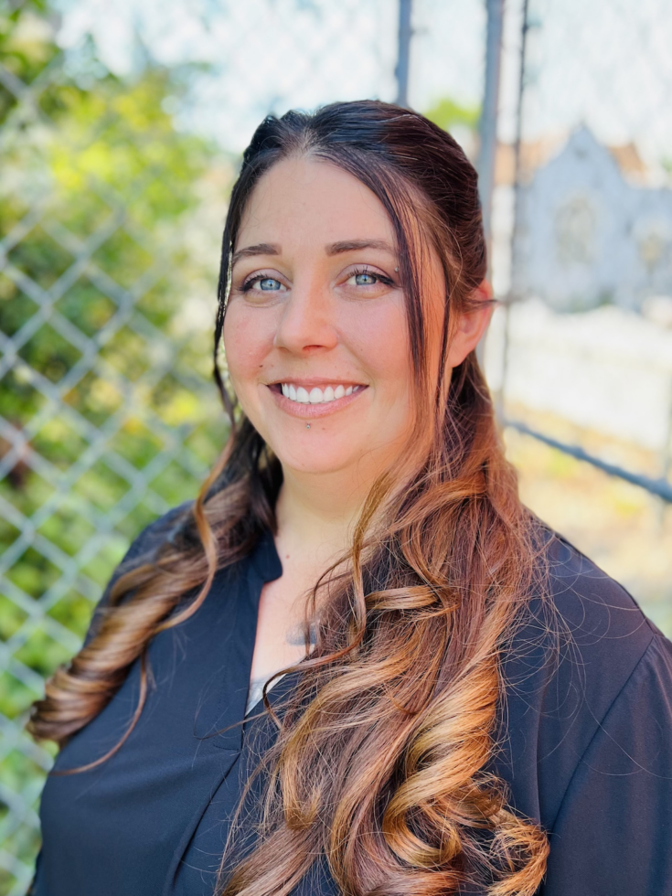 A friendly team member smiles warmly, embodying the welcoming spirit of our vibrant community.