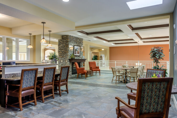 Welcoming common area with seating, fireplace, and dining space for community gatherings.