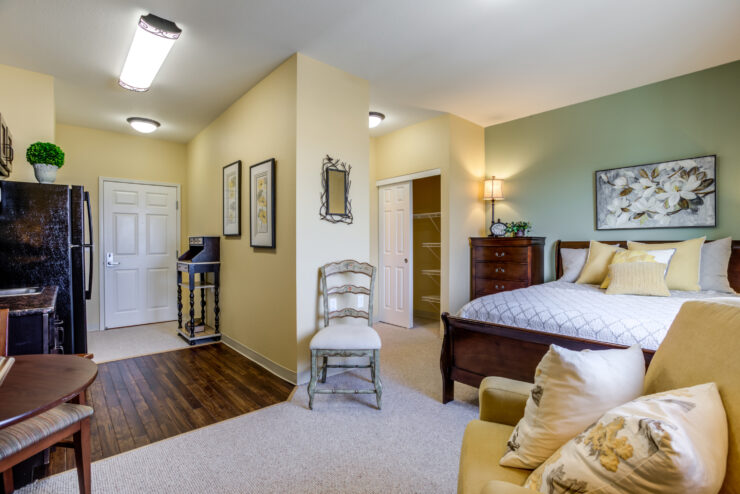 Comfortable and inviting private apartment featuring bedroom, sitting area, and kitchenette.