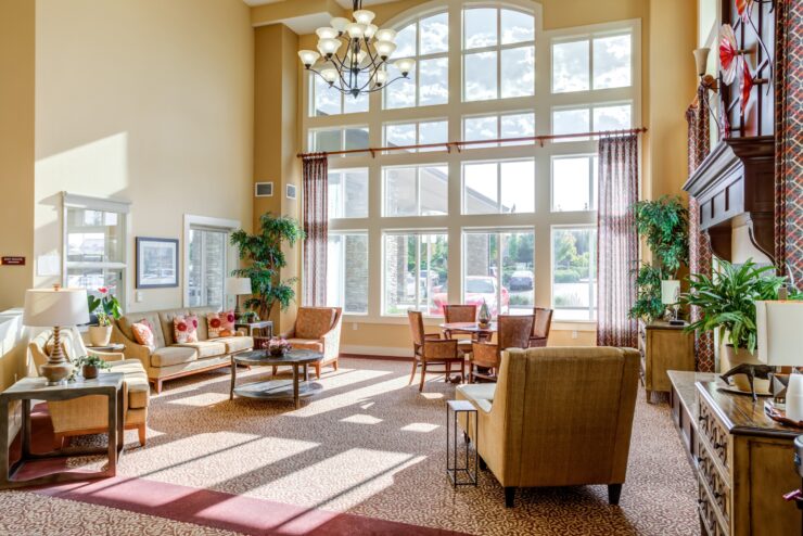 Bright, inviting common area with comfortable seating and large windows fostering community and relaxation.