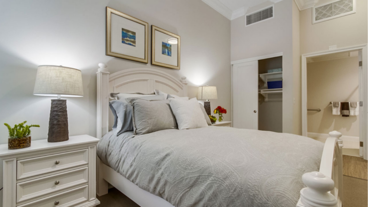 A serene bedroom with elegant decor, inviting comfort, and a warm, welcoming atmosphere for residents.