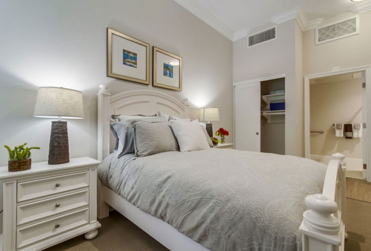 A serene bedroom with elegant decor, inviting comfort, and a warm, welcoming atmosphere for residents.