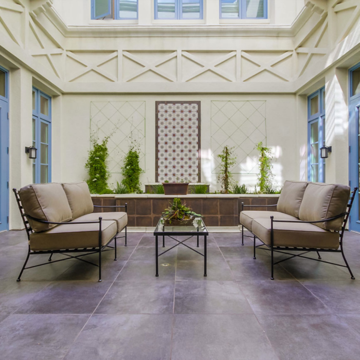 An inviting courtyard with comfortable seating and greenery, perfect for community gatherings.
