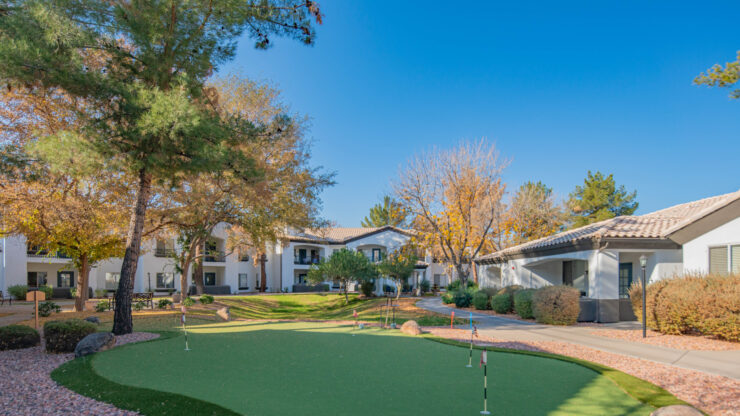 A serene outdoor space with lush greenery, inviting homes, and a welcoming atmosphere for community activities.