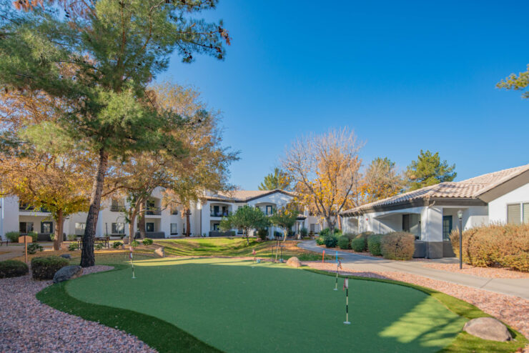 A serene outdoor space with lush greenery, inviting homes, and a welcoming atmosphere for community activities.