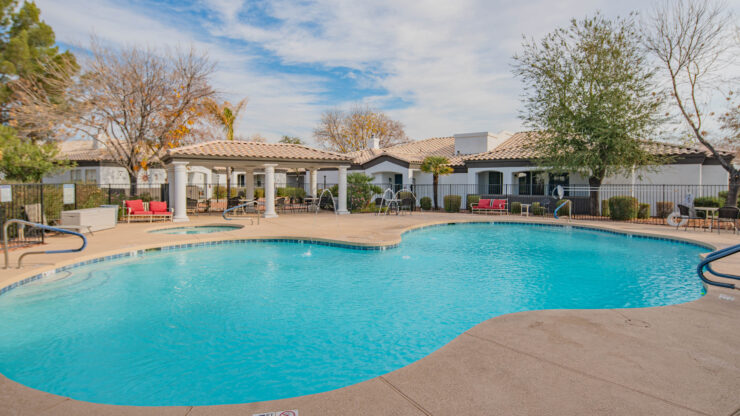 A serene pool area surrounded by charming homes invites relaxation and community connection.