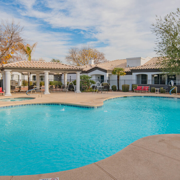 A serene pool area surrounded by charming homes invites relaxation and community connection.