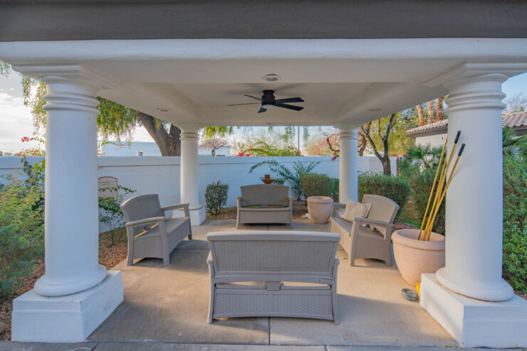 A serene patio with comfortable seating invites community gatherings amidst lush greenery.