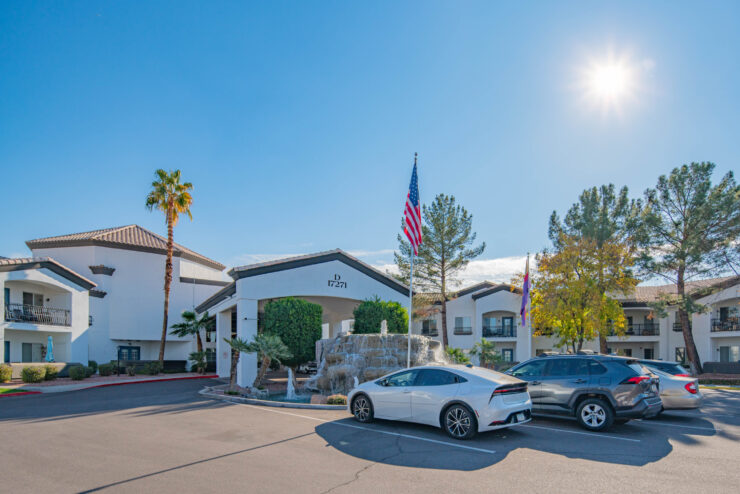 A welcoming entrance with lush landscaping and a soothing fountain, inviting community and connection.