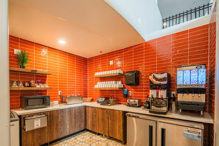 Bright, inviting kitchen space fostering community connection with refreshments and comfort for all.