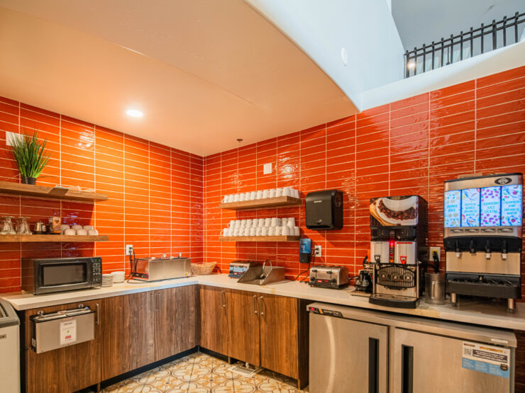 Bright, inviting kitchen space fostering community connection with refreshments and comfort for all.
