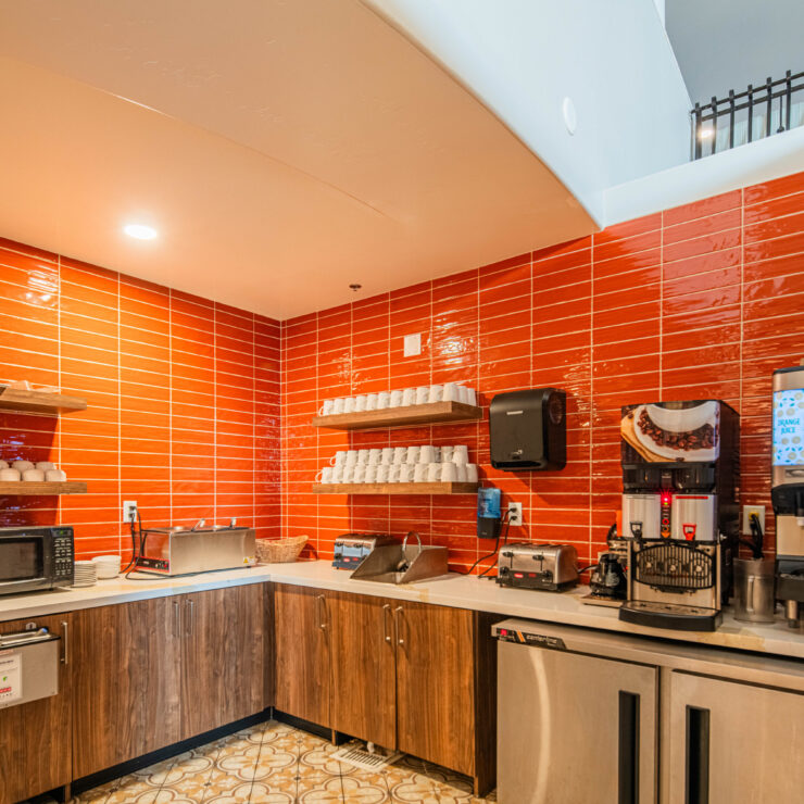 Bright, inviting kitchen space fostering community connection with refreshments and comfort for all.