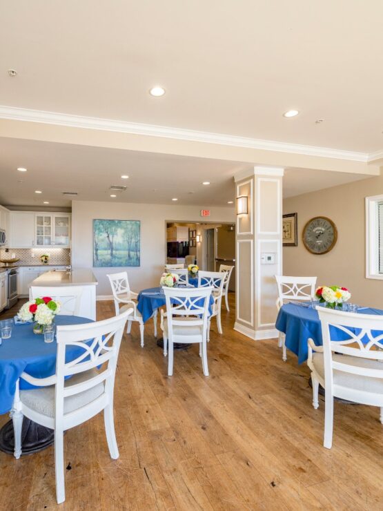 Bright, inviting dining area with cheerful blue tables, fostering community and warmth.