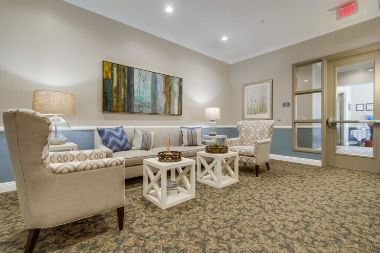 A welcoming lounge area featuring comfortable seating, warm lighting, and vibrant artwork, perfect for community gatherings.