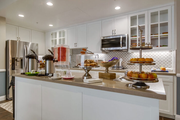 A bright, inviting kitchen showcases fresh fruits and baked goods, fostering a sense of community and warmth.