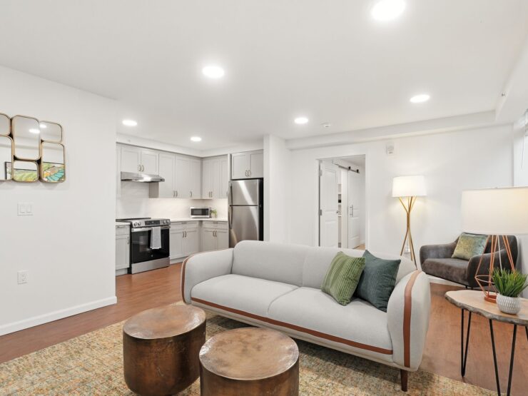 Bright and inviting living space with modern kitchen, comfortable seating, and warm lighting.